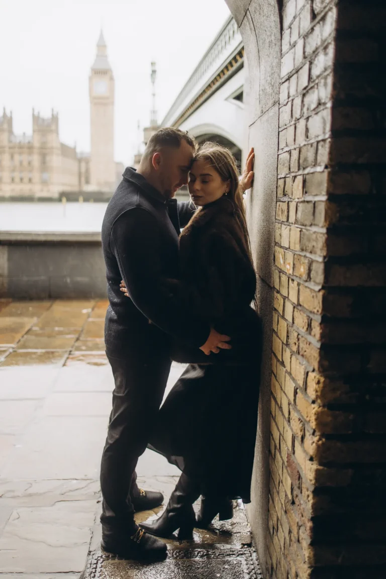 Couple standing forehead to forehead in the arch under Westminster Bridge with Big Ben behind