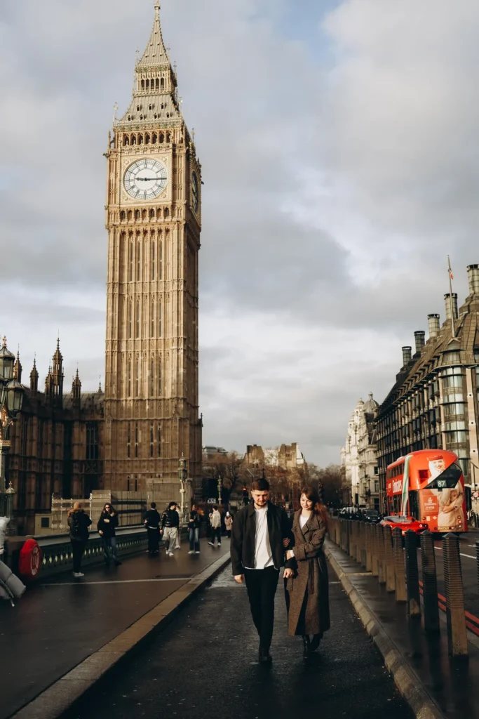 Couple walking arm in arm on Westminster Bridge with Big Ben behind them