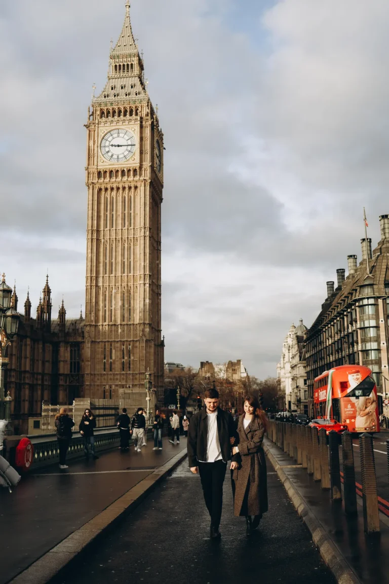 Couple walking arm in arm on Westminster Bridge with Big Ben behind them