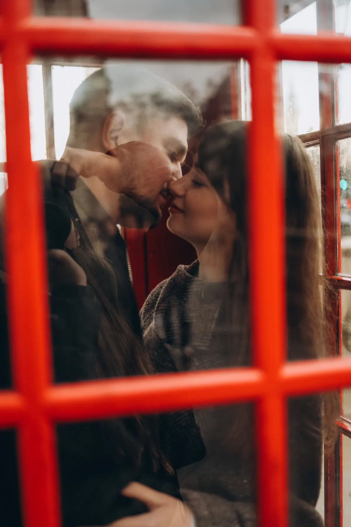 Couple photographed through the glass of a red phone box during a Big Ben photoshoot