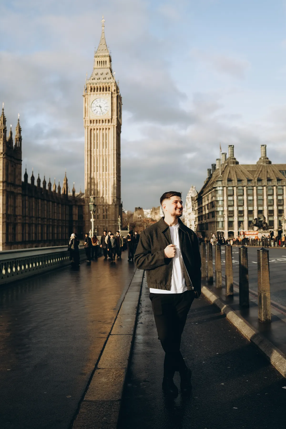 Smiling man on Westminster Bridge in low sun with Big Ben behind