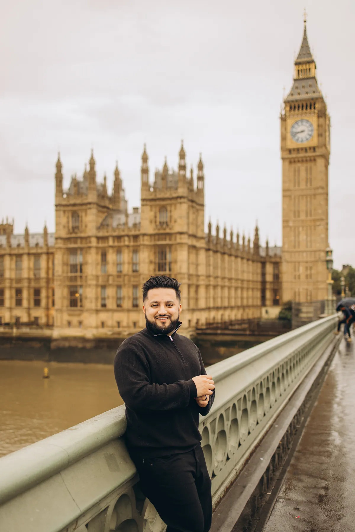 Man smiling on Westminster Bridge with Big Ben and the Houses of Parliament behind